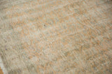 Distressed vintage Oushak rug pile showing even wear, faded pale orange vinery, and fringe.