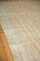 Low pile texture on a distressed vintage Oushak rug, with faded orange and ivory.