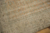 Distressed pile texture of the vintage Oushak rug, with faded floral vinery in soft hues.