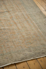 Faded orange and beige distressed Oushak pile with even wear and subtle green tones.