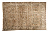 Distressed vintage Oushak carpet with faded beige, brown, and aqua floral vinery.