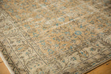 Vintage distressed Oushak carpet border showing aqua blue florals and brown scrolling vinery.