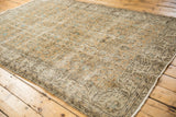 Floral vinery and vine border of a distressed Oushak carpet corner in aqua blue.