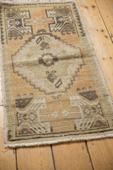 Stepped medallion on a distressed vintage Oushak rug with muted beige and brown tones.