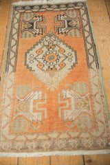 Vintage Distressed Oushak rug: Lower border with meandering vine design and fringe.