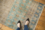 Distressed Sparta rug showcasing its bold floral lattice with vibrant teal, gold, and brown color abrashes.