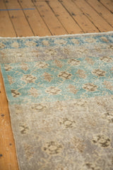 Distressed vintage Sparta rug's faded teal lattice design with silver and grey abrashes.
