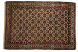 Fine antique Malayer rug with an allover floral lattice pattern in charcoal blue, gold, and wine red.