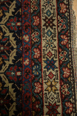Intricate floral and lattice panels with fine knotting on an antique Malayer collector rug.