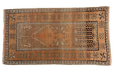 Vintage distressed Oushak rug, copper terra cotta with gray and brown geometric starburst motifs.