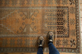 Distressed Turkish Oushak rug, showing starburst patterns, worn pile, and copper terra cotta tones.