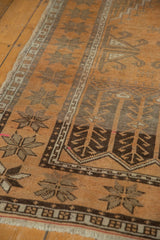 Worn copper terra cotta Oushak rug pile with dark starburst motifs and geometric border.