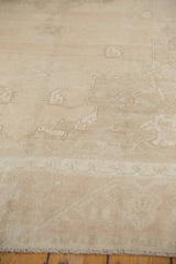 Soft, even low pile of the distressed vintage Oushak rug, showing muted beige and ivory pattern.