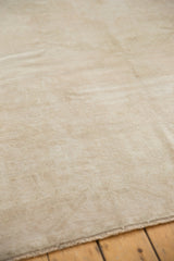 Textured low pile of distressed vintage Oushak carpet in ivory, silver, and beige.