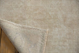 Vintage Oushak carpet showing low ivory pile and its tightly woven reverse.