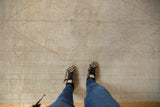 Distressed Oushak rug with subtle ivory, platinum, and beige central medallion and motifs.