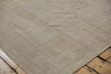 Corner detail of a vintage distressed Oushak rug with soft, low pile.