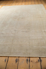 Subtle medallion and germinating seed outlines on distressed silver and ivory Oushak pile.