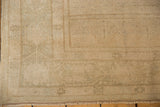 Distressed low pile texture of vintage Oushak rug, muted beige, ivory, subtle pattern.