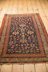 Antique Serbend rug detail showing navy field, splayed floral motifs, botehs, and terra cotta vinery.