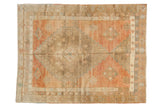 Vintage Distressed Oushak rug, abrashed field, blush, bronze, powder blue geometric motifs.
