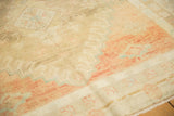 Soft, low pile of a distressed Oushak rug with abrashed blush and powder blue geometric border.