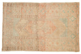 Distressed hand-knotted Turkish Oushak rug featuring pastel blush and seafoam medallion.
