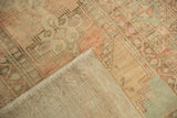 Hand-knotted foundation and original selvage of the Vintage Oushak, with distressed blush and green pile.