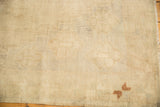 Hand-knotted low pile texture of a distressed Oushak rug showing a corner copper motif.