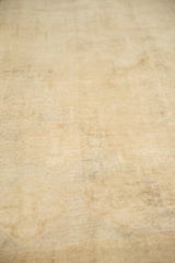 Distressed texture of a vintage Oushak carpet with an even low pile and visible knot heads.