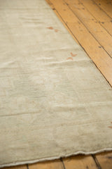 Low pile and knot heads on a distressed vintage Oushak rug in subtle ivory and silver tones.