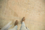 Tone-on-tone shades of sand and ivory across the even low pile of a distressed Oushak carpet.