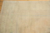 Low-pile texture of a distressed Oushak rug with tone-on-tone sand and pale powder blue.