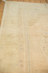 A low angle view showing the distressed rug's even low pile in sand and pale powder blue tones.