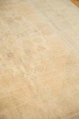 Close view of the vintage Oushak carpet's even low pile and soft, sandy texture.