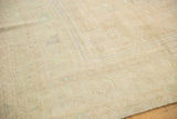 Hand-knotted texture showing the even low pile of a distressed vintage Turkish Oushak rug.