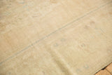 Evenly worn low pile showing visible knot heads and pale blue details on a vintage Oushak.