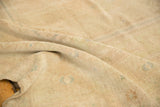Angled close-up of the Oushak carpet's even low pile and sandy, tone-on-tone shades.