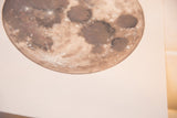 Signature KM19 detail on the textured dark grey moon painting.