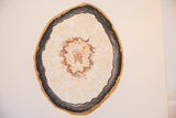 Angled view of Katelyn Morse Black Tourmaline painting, textured cream, dark, and gold geode.