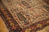 Antique Afshar rug's scarce ivory ground, mallard green tree-of-life, and brick red border.