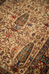 Antique Afshar rug's scarce ivory ground, mallard green tree-of-life pattern, and brick red geometric border.