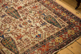 Antique Afshar rug's brick red, indigo border; mallard green tree of life on scarce ivory field.
