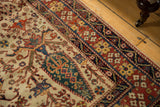 Corner of antique Afshar rug with ivory field, brick red and dark blue borders, and redone selvage.