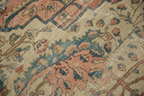 Intricate floral pattern in dusty teal, blush, and ivory with softened pile.