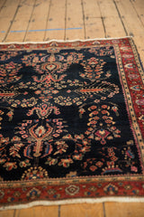 Antique Mohajeran Sarouk rug: navy field, bursting floral motifs, unique wine red palmette border.
