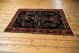 Antique Mohajeran Sarouk rug's wine red border, unique palmette motifs, and deep navy field.