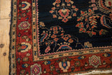 Unique palmette design elements in the wine red main border of an antique Persian Mohajeran Sarouk rug.
