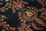 Antique Mohajeran Sarouk rug detail: wine red, blush, and blue florals on navy field.