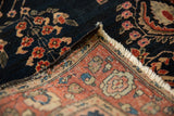 Mohajeran Sarouk rug with navy floral pile, secure fringed edge, and hand-knotted foundation.
